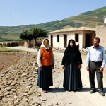 **

A group of families, fully clothed in appropriate attire, stands near a damaged village in Sicily, Italy, after a severe drought. The landscape is arid and cracked. In the background, a relief organization distributes water. The scene is filled with a sense of hope amidst hardship. Safe for work, appropriate content, modest clothing, professional photography, realistic, perfect anatomy, natural proportions.

**